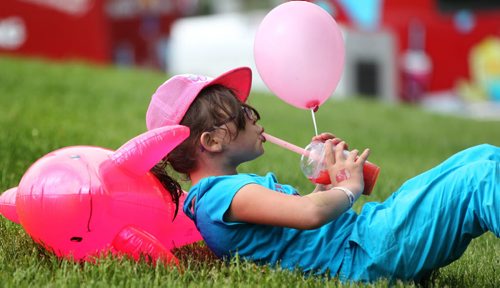 Lily Labossiere sips on her pink ice drink while holding her pink balloon at Kid Fest at the Forks Saturday. Standup photo    June 06, 2015 Ruth Bonneville / Winnipeg Free Press