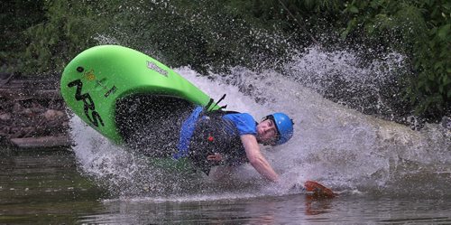 Steve Walker with the Manitoba Whitewater Club goes down the slide at FortWhyte Alive during the MEC Paddlefest.  150607 June 7, 2015 MIKE DEAL / WINNIPEG FREE PRESS