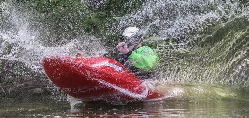 Eric Gemby takes a ride down the slide in a whitewater play boat during MEC Paddlefest at FortWhyte Alive Sunday. 150607 - Sunday, June 07, 2015 -  MIKE DEAL / WINNIPEG FREE PRESS
