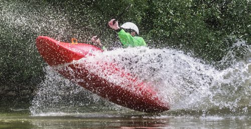 Eric Gemby takes a ride down the slide in a whitewater play boat during MEC Paddlefest at FortWhyte Alive Sunday. 150607 - Sunday, June 07, 2015 -  MIKE DEAL / WINNIPEG FREE PRESS