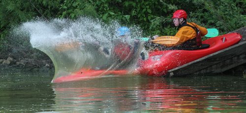 Matthias Penner (blue helmet) and Alex Martin (red helmet) ride down the slide in a double kayak during the MEC Paddlefest at FortWhyte Alive Sunday. 150607 - Sunday, June 07, 2015 -  MIKE DEAL / WINNIPEG FREE PRESS