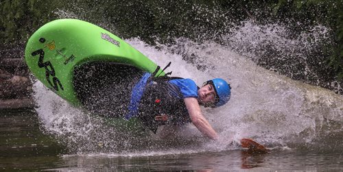 Steve Walker takes a ride down the slide in a whitewater play boat during MEC Paddlefest at FortWhyte Alive Sunday. 150607 - Sunday, June 07, 2015 -  MIKE DEAL / WINNIPEG FREE PRESS