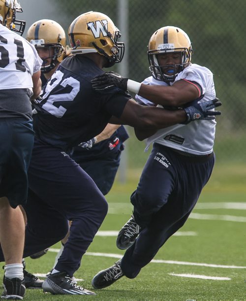 Carlos Anderson (35) rushes the ball past Bryant Turner (92) during Winnipeg Blue Bombers training camp Sunday morning. 150607 - Sunday, June 07, 2015 -  MIKE DEAL / WINNIPEG FREE PRESS