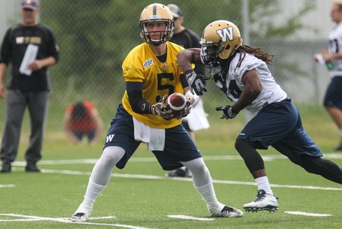 Quarterback Drew Willy (5) goes to hand off the ball to Paris Cotton (34) during Winnipeg Blue Bombers training camp Sunday morning. 150607 - Sunday, June 07, 2015 -  MIKE DEAL / WINNIPEG FREE PRESS