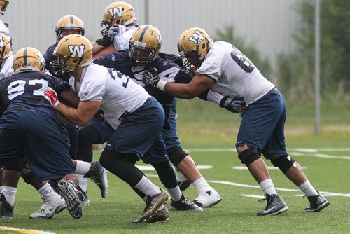 Sukh Chungh (69) keeps the pressure on Zach Anderson (44) during Winnipeg Blue Bombers training camp Sunday morning. 150607 - Sunday, June 07, 2015 -  MIKE DEAL / WINNIPEG FREE PRESS