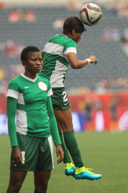 Nigeria's Ngozi Ebere (23) heads a ball during warmup prior to the start of their game against Sweden in FIFA Women's World Cup soccer action in Winnipeg on Monday, June 8, 2015. 150608 - Monday, June 08, 2015 -  MIKE DEAL / WINNIPEG FREE PRESS