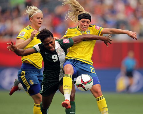 Nigeria's # 9 Desire OPARONOZIE AND SWEDEN'S # 23ELIN RUBENSSON tangle over possession Monday afternoon in Women's World Cup Soccer action in Winnip[eg. See story. June 8, 2015 - (Phil Hossack / Winnipeg Free Press)