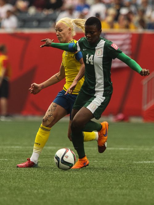 Sweden's Caroline Seger (17) and Nigeria's Evelyn Nwabuoku (14) during FIFA Women's World Cup soccer action in Winnipeg on Monday, June 8, 2015. 150608 - Monday, June 08, 2015 -  MIKE DEAL / WINNIPEG FREE PRESS