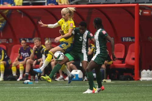 Sweden's Sofia Jakobsson (10) and Nigeria's Osinachi Ohale (3) during FIFA Women's World Cup soccer action in Winnipeg on Monday, June 8, 2015. 150608 - Monday, June 08, 2015 -  MIKE DEAL / WINNIPEG FREE PRESS