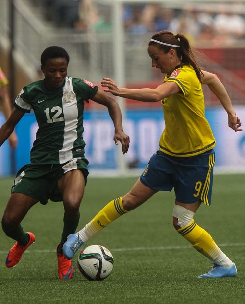 Sweden's Kosovare Asllani (9) and Nigeria's Halimatu Ayinde (12) during FIFA Women's World Cup soccer action in Winnipeg on Monday, June 8, 2015. 150608 - Monday, June 08, 2015 -  MIKE DEAL / WINNIPEG FREE PRESS