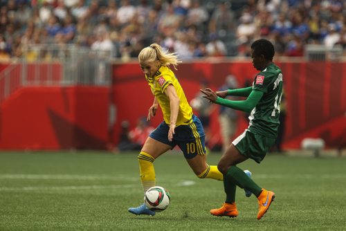 Sweden's Sofia Jakobsson (10) and Nigeria's Evelyn Nwabuoku (14) during FIFA Women's World Cup soccer action in Winnipeg on Monday, June 8, 2015. 150608 - Monday, June 08, 2015 -  MIKE DEAL / WINNIPEG FREE PRESS