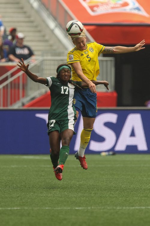 Sweden's Nilla Fischer (5) heads the ball while Nigeria's Francisca Ordega (17) tries to slow her down during the first half of FIFA Women's World Cup soccer action in Winnipeg on Monday, June 8, 2015. 150608 - Monday, June 08, 2015 -  MIKE DEAL / WINNIPEG FREE PRESS