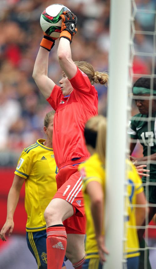 Sweden's netminder Hedvig Lindahl goes up for the save in traffic Monday afternoon in Women's World Cup Soccer action in Winnipeg. June 8, 2015 - (Phil Hossack / Winnipeg Free Press)