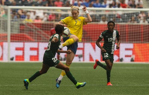 Sweden's Lisa Dahlkvist (7) tries to take a pass from across the field while Nigeria's Ngozi Ebere (23) moves in during the first half of FIFA Women's World Cup soccer action in Winnipeg on Monday, June 8, 2015. 150608 - Monday, June 08, 2015 -  MIKE DEAL / WINNIPEG FREE PRESS