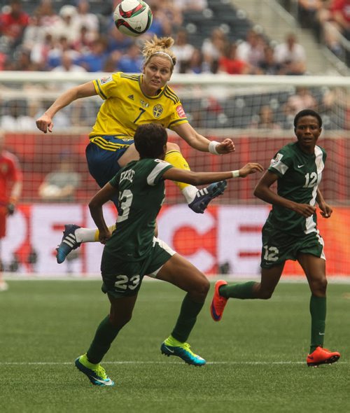 Sweden's Lisa Dahlkvist (7) tries to take a pass from across the field while Nigeria's Ngozi Ebere (23) moves in during the first half of FIFA Women's World Cup soccer action in Winnipeg on Monday, June 8, 2015. 150608 - Monday, June 08, 2015 -  MIKE DEAL / WINNIPEG FREE PRESS