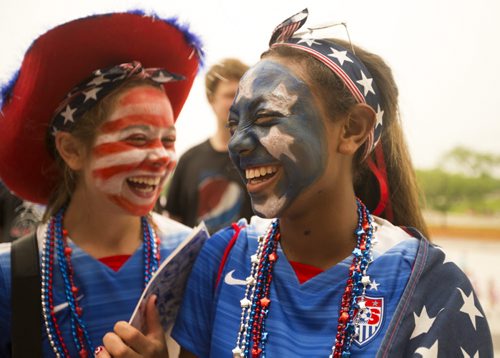Sadie Koltes (right) and her friend, Sophia Boman, giggle as they wait in  line to see the Nigeria vs. Sweden game at the Investors Group Field on Monday, June 8, 2015.  Both girls are 13 and play on the Minnesota Thunder Academy soccer team. Mikaela MacKenzie / Winnipeg Free Press