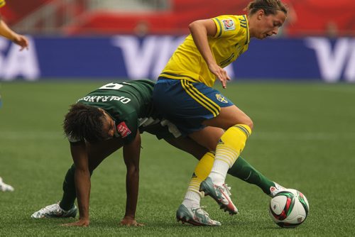 Nigeria's Desire Oparanozie (9) tries to keep the ball from Sweden's Lina Nilsson (16) during the second half of FIFA Women's World Cup soccer action in Winnipeg on Monday, June 8, 2015. 150608 - Monday, June 08, 2015 -  MIKE DEAL / WINNIPEG FREE PRESS