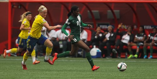 Nigeria's Asisat Oshoala (8) runs the ball up field past Sweden's Nilla Fischer (5) eventually scoring a goal during the second half of FIFA Women's World Cup soccer action in Winnipeg on Monday, June 8, 2015. 150608 - Monday, June 08, 2015 -  MIKE DEAL / WINNIPEG FREE PRESS