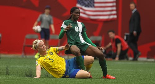 Nigeria's Asisat Oshoala (8) watches her shot go into the net for a goal while Sweden's Nilla Fischer (5) reacts during the second half of FIFA Women's World Cup soccer action in Winnipeg on Monday, June 8, 2015. 150608 - Monday, June 08, 2015 -  MIKE DEAL / WINNIPEG FREE PRESS