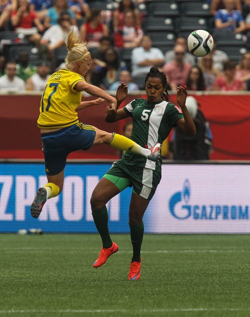 Sweden's Caroline Seger (17) and Nigeria's Onome Ebi (5) during the second half of FIFA Women's World Cup soccer action in Winnipeg on Monday, June 8, 2015. 150608 - Monday, June 08, 2015 -  MIKE DEAL / WINNIPEG FREE PRESS