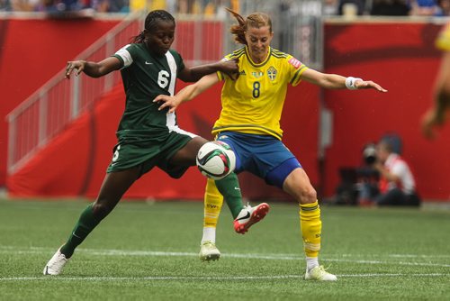 Nigeria's Josephine Chukwunonye (6) and Sweden's Lotta Schelin (8) during the second half of FIFA Women's World Cup soccer action in Winnipeg on Monday, June 8, 2015. 150608 - Monday, June 08, 2015 -  MIKE DEAL / WINNIPEG FREE PRESS