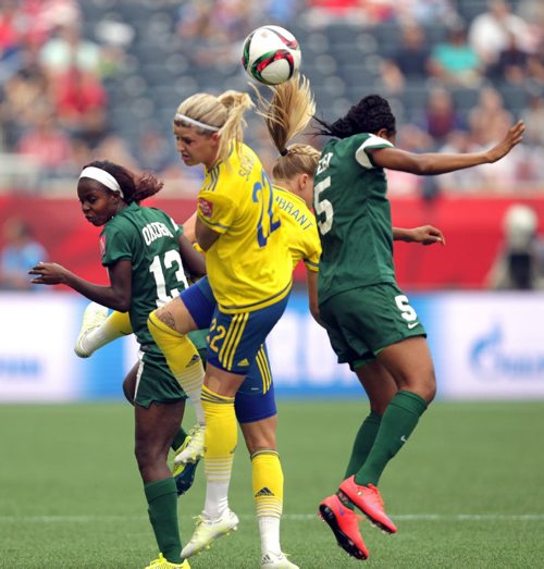 Nigeria's #13, Ngozi Okobi, Sweden's #22 Olivia Schough and Nigeria's #5 Onome Ebi collide fielding the ball Monday afternoon in WOrld Cup action at Investor's Group Field. See story. June 8, 2015 - (Phil Hossack / Winnipeg Free Press)