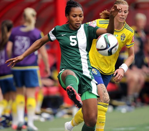 Nigeria's #5 Onome Ebi handles the ball while Sweden's #8 Lotta Schelin pursues  Monday afternoon in WOrld Cup action at Investor's Group Field. See story. June 8, 2015 - (Phil Hossack / Winnipeg Free Press)