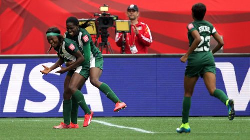 Nigeria's #17 Francisca Ordega celebrates wrapped up in the arms of team mate #8 Asisat Oshoala after tying the game at 3 against Sweden Monday afternoon in World Cup action at Investor's Group Field. See story. June 8, 2015 - (Phil Hossack / Winnipeg Free Press)