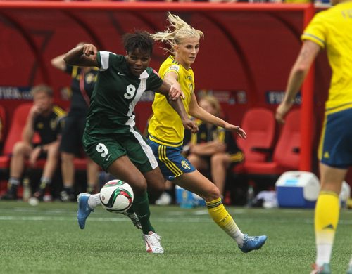 Nigeria's Desire Oparanozie (9) and Sweden's Sofia Jakobsson (10) during the second half of FIFA Women's World Cup soccer action in Winnipeg on Monday, June 8, 2015. 150608 - Monday, June 08, 2015 -  MIKE DEAL / WINNIPEG FREE PRESS