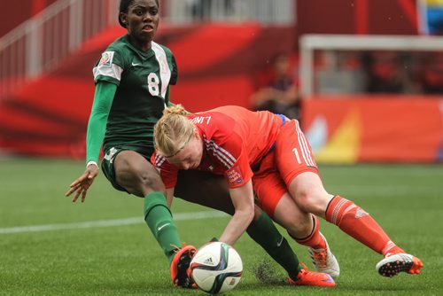 Nigeria's Asisat Oshoala (8) collides with Sweden's goalkeeper Hedvig Lindahl (1) during the second half of FIFA Women's World Cup soccer action in Winnipeg on Monday, June 8, 2015. 150608 - Monday, June 08, 2015 -  MIKE DEAL / WINNIPEG FREE PRESS