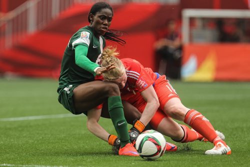 Nigeria's Asisat Oshoala (8) collides with Sweden's goalkeeper Hedvig Lindahl (1) during the second half of FIFA Women's World Cup soccer action in Winnipeg on Monday, June 8, 2015. 150608 - Monday, June 08, 2015 -  MIKE DEAL / WINNIPEG FREE PRESS