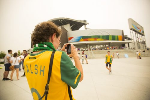 Glenda Sorokin takes a photo of her daughter, Maggie Price, in front of the stadium before the Nigeria vs. Sweden game at the Investors Group Field on Monday, June 8, 2015.  They traveled all the way from Sydney, Australia to see the FIFA World Cup. Mikaela MacKenzie / Winnipeg Free Press