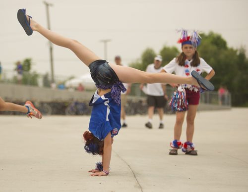 Heather Shearman, 11, does handstands before going in to see the Nigeria vs. Sweden game at the Investors Group Field on Monday, June 8, 2015. Mikaela MacKenzie / Winnipeg Free Press