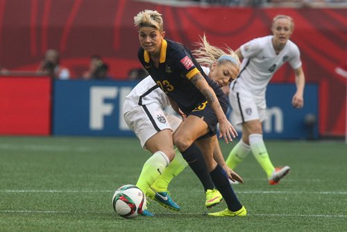 USA's Julie Johnston (19) tries to take the ball away from Australia's Michelle Heyman (23) during FIFA Women's World Cup soccer action in Winnipeg on Monday, June 8, 2015. 150608 - Monday, June 08, 2015 -  MIKE DEAL / WINNIPEG FREE PRESS