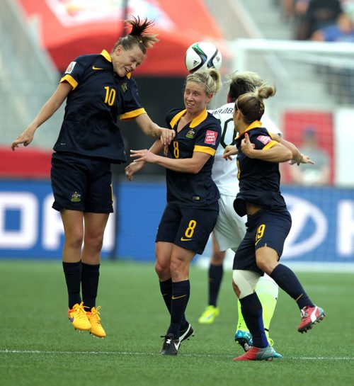 Team Australia's #10 Emily Van Egmond and #8 Elsie Kellond-Knight go up out of the crowd to head the ball   Monday at Investor's Field in FIFA action against team USA. June 8, 2015 - (Phil Hossack / Winnipeg Free Press)