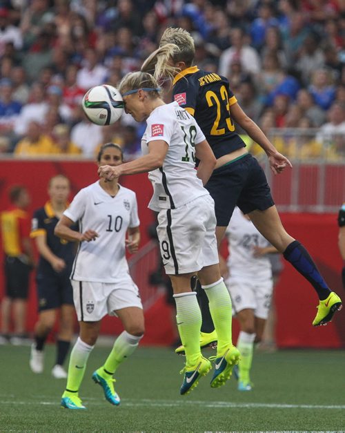 USA's Julie Johnston (19) heads the ball while Australia's Michelle Heyman (23) misses during the second half of FIFA Women's World Cup soccer action in Winnipeg on Monday, June 8, 2015. 150608 - Monday, June 08, 2015 -  MIKE DEAL / WINNIPEG FREE PRESS
