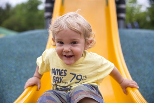 David Kleiner, 14 months, stops at the end of the slide at a playground in Assiniboine Park in Winnipeg on Tuesday, June 9, 2015. Mikaela MacKenzie / Winnipeg Free Press