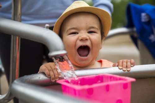 Rhys Daulat, 14 months, plays in the water on a warm but overcast day in Assiniboine Park in Winnipeg on Tuesday, June 9, 2015. Mikaela MacKenzie / Winnipeg Free Press