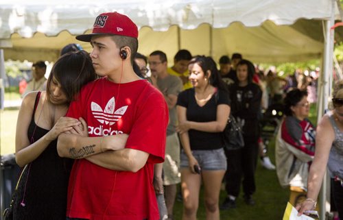 Danielle Lambert (left) and Travis Moar stand in line to receive their treaty cheques at the Forks in Winnipeg on Tuesday, June 9, 2015.  After waiting through the whole line, Moar was unable to get his treaty cheque because he didn't have photo identification. Mikaela MacKenzie / Winnipeg Free Press