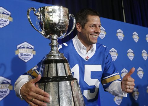 Mayor Brian Bowman poses with the Grey Cup at the University of Winnipegs Health & RecPlex Tuesday after the announcement of the 103rd Grey Cup Festival events Nov.25-29. Scott Billeck story. Wayne Glowacki / Winnipeg Free Press June 9 2015