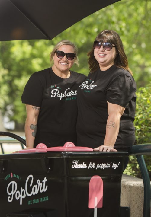 Angela Farkas (left) and Alana Fiks showcase their freshly made popsicles in a cart at the Forks in Winnipeg on Tuesday, June 9, 2015.  The two have been in business for less than a year, but they feel that there is a niche for their refreshing sweets. Mikaela MacKenzie / Winnipeg Free Press