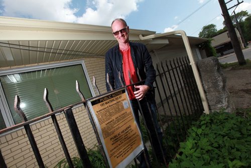 Paul Edmond, CEO of EFG, has bought a house on Waterloo street across the street from his business location on Acadamy and and plans to bulldoze it to build a two-storey commercial building. He's posing  at the rear of the Waterloo house with a public notice for re-zoning. See Kirbyson story. June 9, 2015 - (Phil Hossack / Winnipeg Free Press)