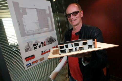 Paul Edmond, CEO of EFG, has bought a house on Waterloo street across the street from his business location on Acadamy and and plans to bulldoze it to build a two-storey commercial building. He's posing with a drawing and model of the proposed development. See Kirbyson story. June 9, 2015 - (Phil Hossack / Winnipeg Free Press)