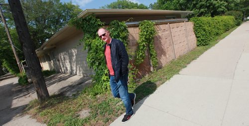Paul Edmond, CEO of EFG, has bought a house on Waterloo street across the street from his business location on Acadamy and and plans to bulldoze it to build a two-storey commercial building. He's posing on Acadamy at the side of the Waterloo house. See Kirbyson story. June 9, 2015 - (Phil Hossack / Winnipeg Free Press)