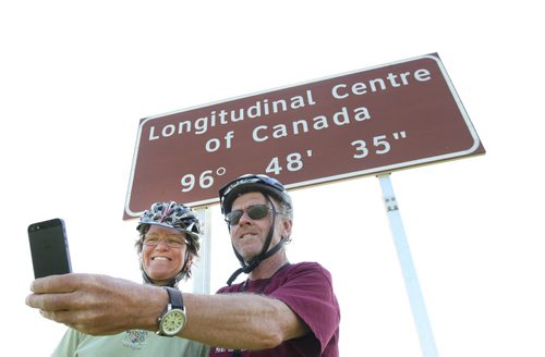 Cyclists Guy Paquin and Valerie Valiulis are traveling across Canada ( West to East) on their bikes and stop for a selfie photo at the Centre of Canada on Hyw 1 East- They welcomed the news that a committee spearheading construction of a 20 acre wayside park on the TransCanada to mark the Centre of Canada, to be completed for Canada's 150th birthday in 2017. See Bill Redekop