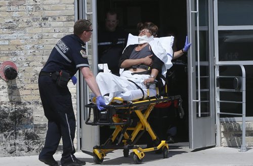 Winnipeg Police and Paramedics on the scene of the Neechi Commons building on Main Street at Euclid Ave. Wednesday afternoon where a person was taken out on a stretcher and taken to the hospital.  Police tape was put up at the entrance to the building.  Wayne Glowacki / Winnipeg Free Press June 10 2015