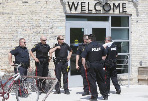 Winnipeg Police on the scene of the Neechi Commons building on Main Street at Euclid Ave. Wednesday afternoon where a person was taken out on a stretcher and taken to the hospital.  Police tape was put up at the entrance to the building. . Wayne Glowacki / Winnipeg Free Press June 10 2015