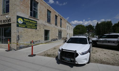Winnipeg Police tape on the scene by the doors to the Neechi Commons building on Main Street at Euclid Ave. Wednesday afternoon where a person was taken out on a stretcher and taken to the hospital. Wayne Glowacki / Winnipeg Free Press June 10 2015