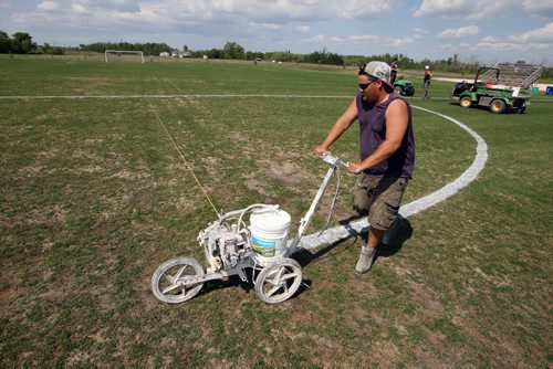 LOCAL -SOCCER FIELDS - Buhler Recreation Park. Logan Anderson paints lines on the field. The grass is pretty worn down centre field. They said that they are going to reseed it at the end of the month to keep it up. BORIS MINKEVICH/WINNIPEG FREE PRESS June 10, 2015