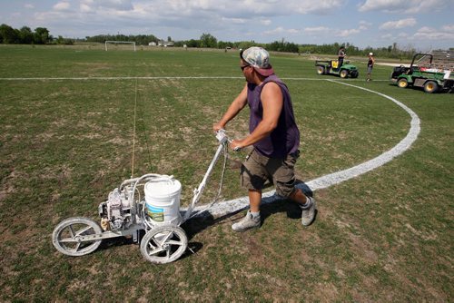 LOCAL -SOCCER FIELDS - Buhler Recreation Park. Logan Anderson paints lines on the field. The grass is pretty worn down centre field. They said that they are going to reseed it at the end of the month to keep it up. BORIS MINKEVICH/WINNIPEG FREE PRESS June 10, 2015